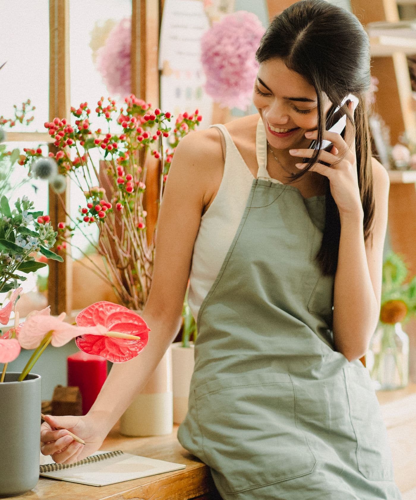 Florist answering a customer on the phone in her shop